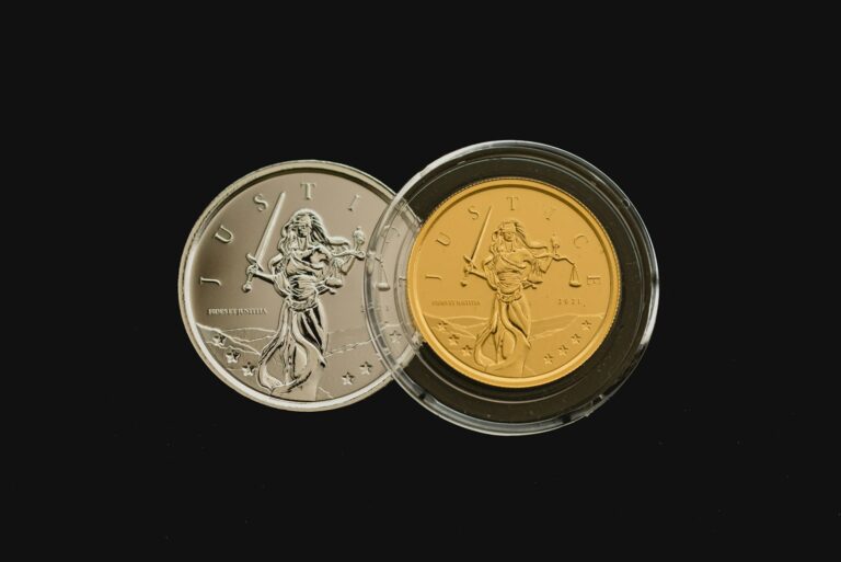 A silver coin and a gold coin side by side