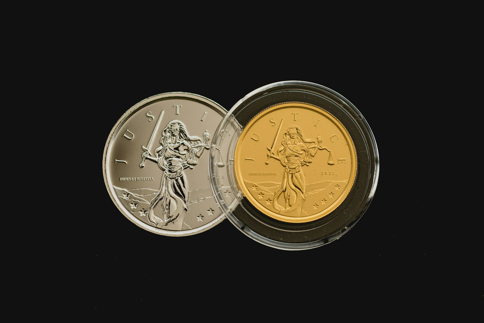 A silver coin and a gold coin side by side