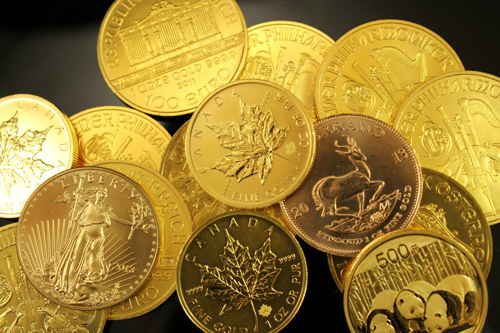 Gold bullion coins including American Gold Eagles and Canadian Maple Leafs