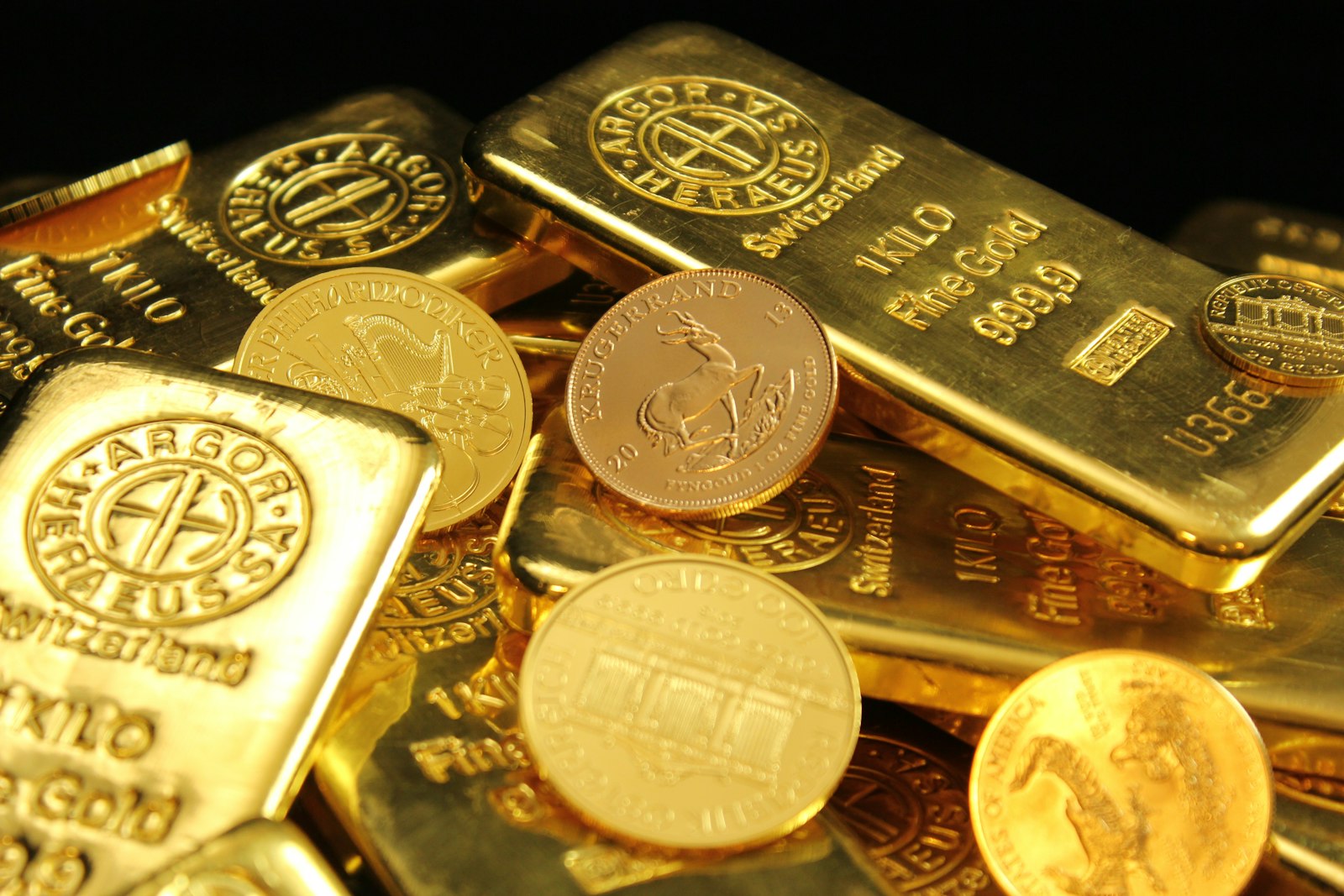 Gold coins and gold bars side by side